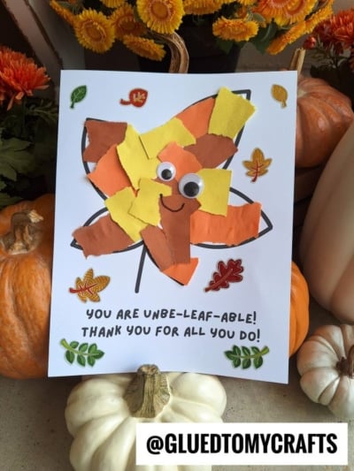 A fall-themed craft features a smiling torn paper leaf made from orange, brown, and yellow bits with googly eyes, surrounded by stickers. Below, text reads: “YOU ARE UNBE-LEAF-ABLE! THANK YOU FOR ALL YOU DO!”.