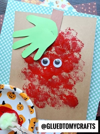 USE A POM POM TO STAMP A RED APPLE ON PAPER