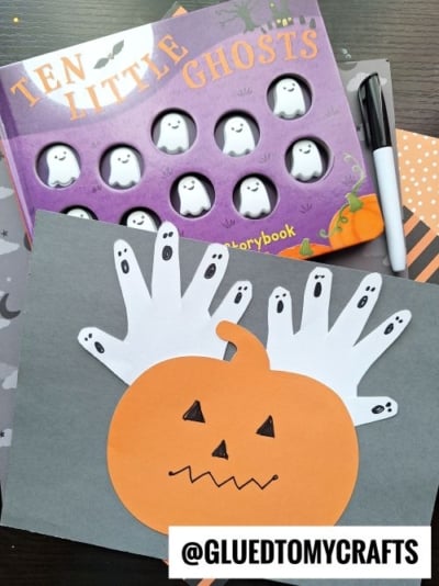 HANDPRINT GHOSTS BEHIND PAPER PUMPKIN