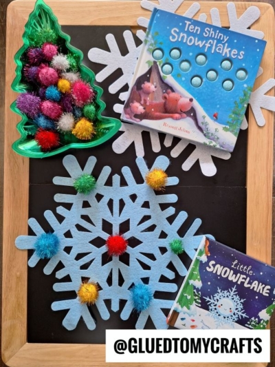 USE LARGE FELT SNOWFLAKE CUTOUTS AND POM POMS FOR THIS WINTER TABLE IDEA