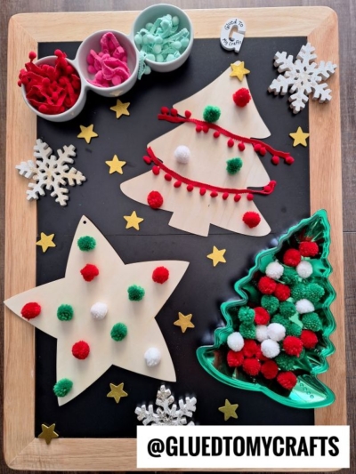 GRAB LARGE WOOD CUTOUTS AND DECORATE WITH POM POMS AND RIBBON