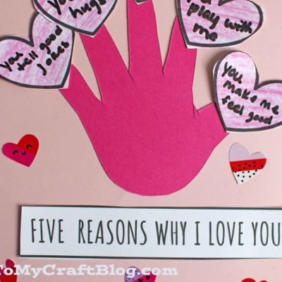 A handmade Valentine card featuring a pink valentine's day handprint, each finger topped with a heart listing reasons for love. Text reads Five Reasons Why I Love You and Free Printable! on a heart-decorated background.
