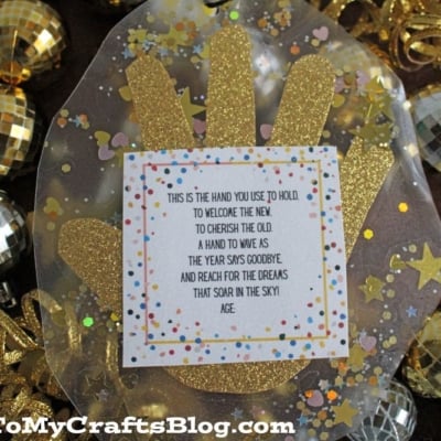 A new year's eve handprint craft with gold glitter and confetti surrounds a poem about saying goodbye to the old year. Disco ball ornaments and gold ribbon decorate the background.