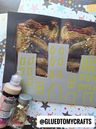A paper with a drawing and a bottle of glitter—perfect supplies for fun New Year’s Eve Crafts For Kids.