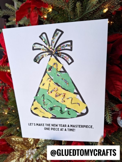 A handmade Torn Paper New Year’s Eve Hat craft, featuring green and yellow torn paper glued to an outline on white paper with glitter accents. The page reads: “LET’S MAKE THE NEW YEAR A MASTERPIECE, ONE PIECE AT A TIME!”.