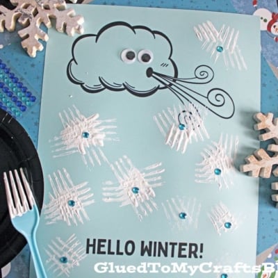 A winter craft page featuring a cartoon cloud blowing wind, googly eyes, fork painted snowflakes with blue gems, and the text HELLO WINTER!