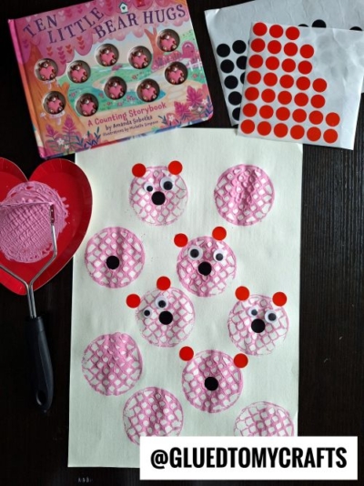 A fun Valentine's Day craft idea for kids: Create paper ladybugs using pink painted circles, black sticker eyes, and red dot stickers. Complete the activity with a heart-shaped paint tray, sticker sheets, a book, and more creative supplies.