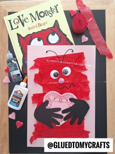 A children’s craft project inspired by Love Monster, perfect for valentine's day craft ideas for kids—create a red, textured monster with googly eyes, a heart-shaped doily, black handprint cutouts, plus fun supplies and the Love Monster book.