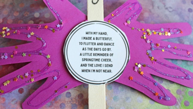 A purple paper butterfly made from handprint cutouts is decorated with glitter and a smiling face. A round poem about sending love is in the center. The background is colorful and the GluedToMyCraftsBlog.com watermark is visible.