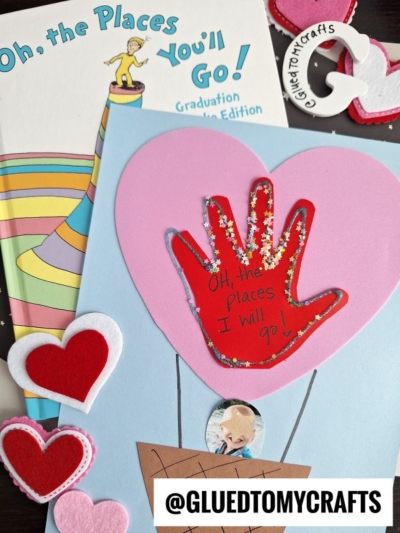 A handmade card with a red handprint balloon reads “Oh, the Places I Will Go!” next to felt heart decorations and a book titled “Oh, the Places You’ll Go! Graduation Edition.” The @GLUEDTOMYCRAFTS handle is visible.
