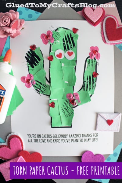 A colorful, handmade cactus craft with a glue bottle, hearts, and decorative paper. 