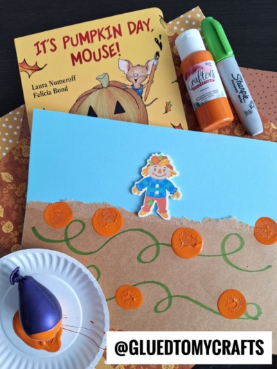 A children’s pumpkin-themed setup for FALL CRAFTS FOR KIDS, featuring the “Pumpkin Day, Mouse!” book, orange paint, markers, patterned papers, a painted pumpkin art project, a balloon stamper, and @GLUETOMYCRAFTS watermark.