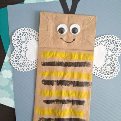 A paper bag with a bee drawn on it.
