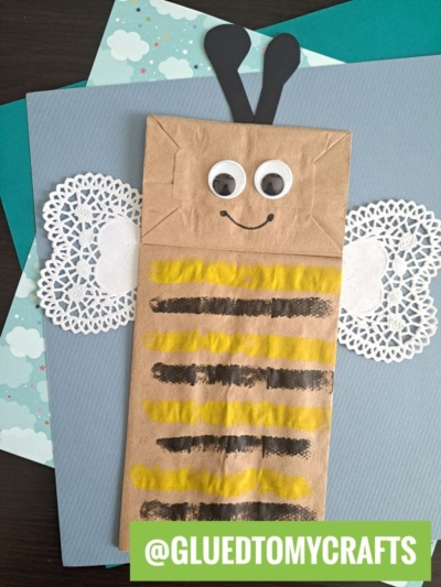 A paper bag with a bee drawn on it.