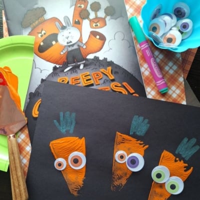 This carrot-themed Halloween craft for kids uses orange paint, googly eyes, green crayons, and black paper. Supplies include paint, googly eyes, markers, and the book “Creepy Carrots!”—perfect for fun Halloween crafts for kids.