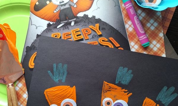 This carrot-themed Halloween craft for kids uses orange paint, googly eyes, green crayons, and black paper. Supplies include paint, googly eyes, markers, and the book “Creepy Carrots!”—perfect for fun Halloween crafts for kids.