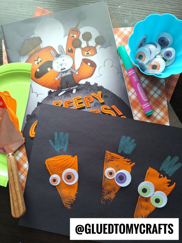 This carrot-themed Halloween craft for kids uses orange paint, googly eyes, green crayons, and black paper. Supplies include paint, googly eyes, markers, and the book “Creepy Carrots!”—perfect for fun Halloween crafts for kids.