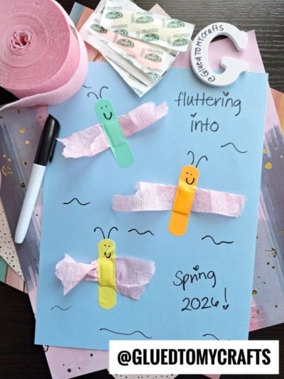 A blue paper features three butterfly crafts made from colored popsicle sticks and pink crepe paper, perfect for INSECT CRAFT IDEAS. The text reads fluttering into Spring 2024! Craft supplies, a black marker, and a @GLUEDTOMYCRAFTS label are also visible.