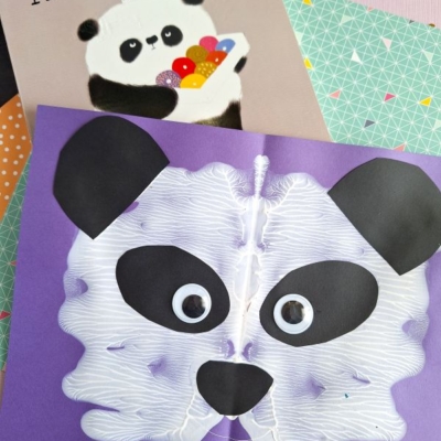 Children’s book Please, Mr. Panda and a symmetrical panda face craft made with white paint, paper cutouts, and googly eyes on purple paper, displayed on patterned sheets. @GLUEDTOMYCRAFTS is written at the bottom.