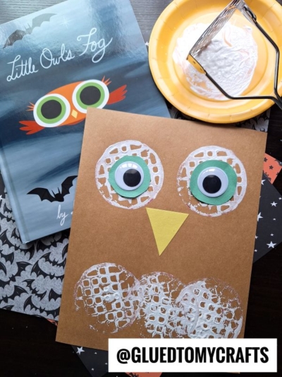 Brown construction paper with a white and yellow owl potato masher stamped craft, next to a Little Owls Fog book, a yellow plate with white paint and masher, plus a bat-printed cloth. Text: @GLUEDTOMYCRAFTS at the bottom.