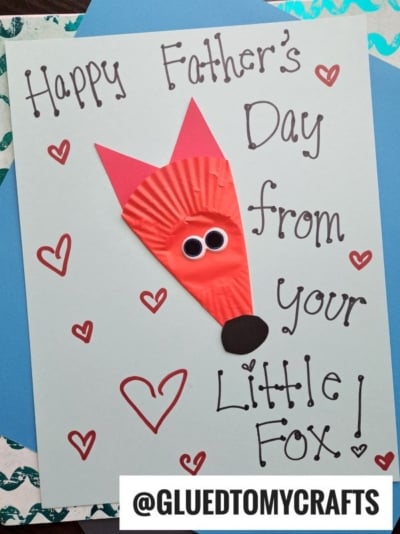 Handmade Father’s Day cupcake liner card crafts feature “Happy Father’s Day from your little fox!” around a cute fox face made from a red cupcake liner, googly eyes, and paper ears, plus red hearts. @GLUEDTOMYCRAFTS at the bottom.