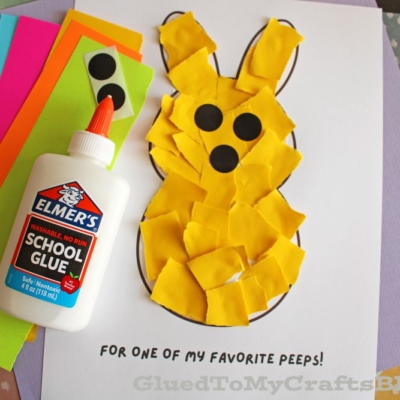 A bunny craft made from yellow torn paper pieces glued to a white sheet, with black paper circles for eyes and nose, a bottle of Elmer’s glue, and colored paper sheets in the background. Text reads: “FOR ONE OF MY FAVORITE PEEPS!”.