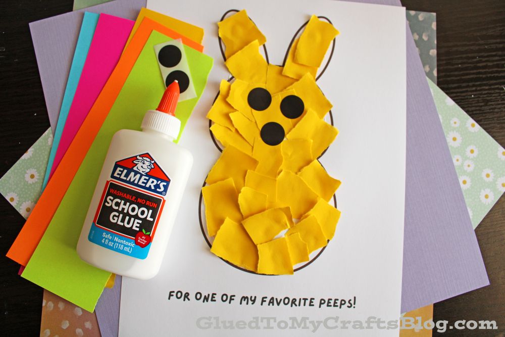 A bunny craft made from yellow torn paper pieces glued to a white sheet, with black paper circles for eyes and nose, a bottle of Elmer’s glue, and colored paper sheets in the background. Text reads: “FOR ONE OF MY FAVORITE PEEPS!”.