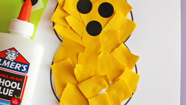 A childrens craft project shows a bunny shape filled with torn yellow paper, black paper circles for eyes and nose, a bottle of Elmers glue, colorful paper squares, and text reading For one of my favorite peeps! FREE PRINTABLE!!!.