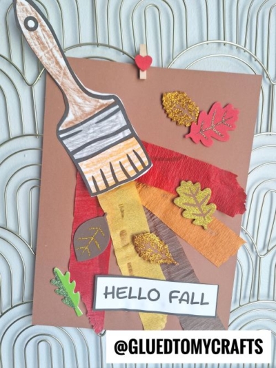 A fall-themed crepe paper craft idea features a paper paintbrush painting strips of colored paper resembling autumn leaves, with cut-out and glittery leaves on a brown background. A HELLO FALL label and @GLUEDTOMYCRAFTS tag are at the bottom.