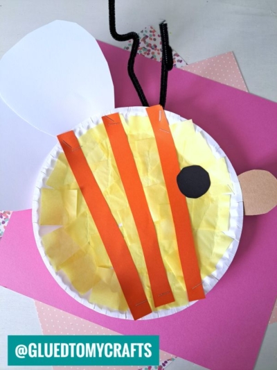 A fun INSECT CRAFT IDEA: make a bee from a paper plate with yellow tissue paper, orange paper stripes, white wings, a black circle for the eye, a brown oval side wing, and black pipe cleaner antennae.