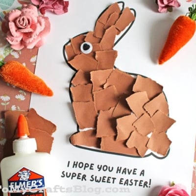 A paper craft of a bunny made from torn brown paper on white paper, with the message I hope you have a super sweet Easter! Nearby are fake flowers, carrots, a bottle of glue, and patterned paper.