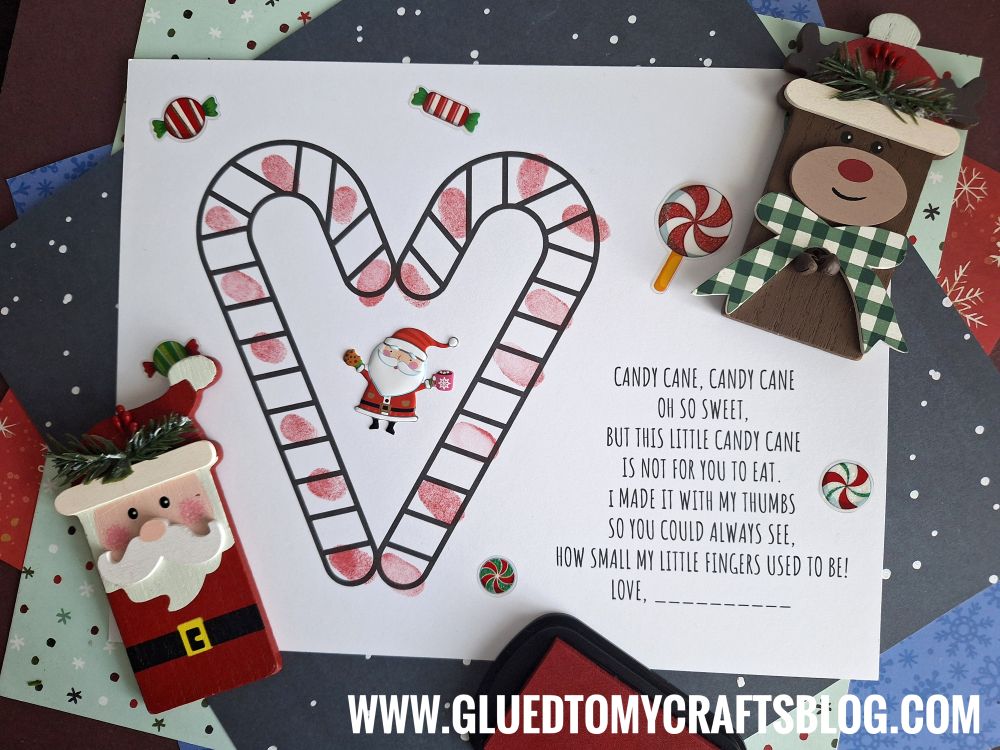 A Christmas-themed Candy Cane Keepsake Landing Page features a large candy cane outline, small Santa sticker, festive poem, with wooden Santa and reindeer decorations plus candy illustrations. GLUEDTOMYCRAFTSBLOG.COM appears at the bottom.