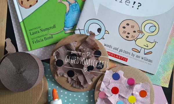 Two children’s books, “If You Give a Mouse a Cookie” and “The Duckling Gets a Cookie!?”, are displayed with craft supplies: colored paper, brown circles, cutouts, glue, tissue, and sticker dots. @GLUEDTOMYCRAFTS is labeled.