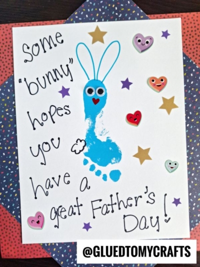 A handmade HANDPRINT FATHER'S DAY card showcases a blue footprint bunny with googly eyes, heart and star stickers, plus the sweet message: Some bunny hopes you have a great Fathers Day! @GLUEDTOMYCRAFTS.