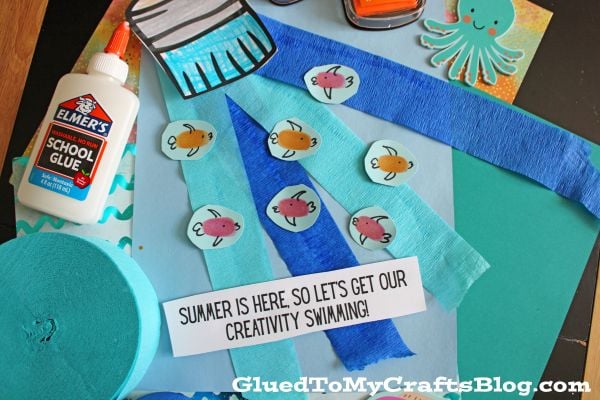 A selection of craft supplies, including Elmers glue, construction paper, paper fish cutouts, ink pads, an octopus shape, blue crepe paper, and a sign that says Summer is here—perfect for creativity on our Summer Printables - Landing Page!.