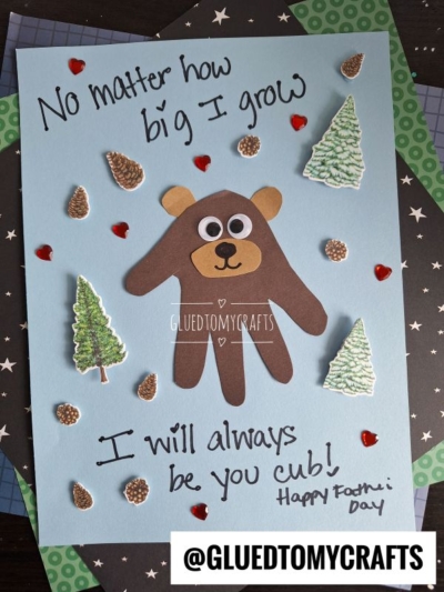 A handmade HANDPRINT FATHER'S DAY card featuring a bear made from a traced handprint, surrounded by trees and hearts. The card reads: No matter how big I grow, I will always be your cub! Happy Fathers Day.