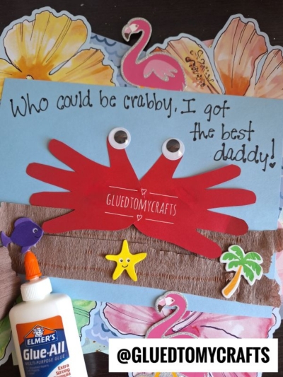 A handmade HANDPRINT FATHER'S DAY card features a red crab with googly eyes, tropical stickers, and “Who could be crabby, I got the best daddy!” Craft supplies and the handle @GLUEDTOMYCRAFTS are also visible.
