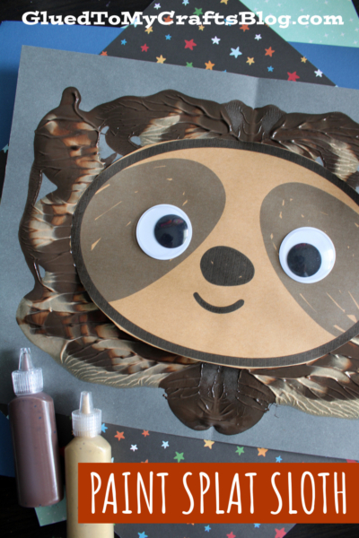 A sloth craft made with paint splat technique, featuring large googly eyes on a brown and tan sloth face. Bottles of brown and beige paint sit nearby on a colorful star-patterned surface. Text: Paint Splat Sloth.