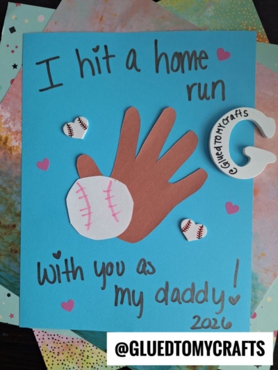 A handmade HANDPRINT FATHER'S DAY card features a brown handprint, a paper baseball glove and ball, small heart and baseball graphics, with the message I hit a home run with you as my daddy! 2026. @GLUEDTOMYCRAFTS appears at the bottom.