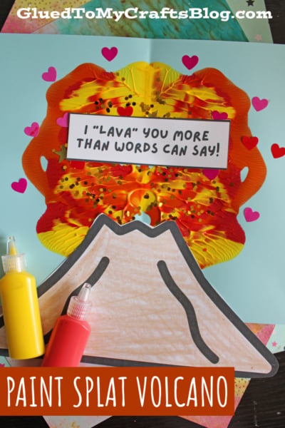 A colorful volcano craft made with red, yellow, and orange paint splats on blue paper. A sign reads I LAVA YOU MORE THAN WORDS CAN SAY! surrounded by heart shapes, with paint bottles below. Text: PAINT SPLAT VOLCANO.