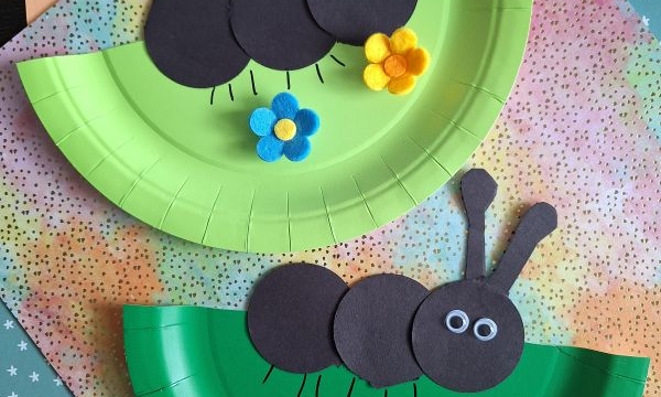 Two paper plate crafts shaped like ants, made with green plates, black paper circles, felt flowers, and googly eyes, are displayed on patterned paper backgrounds. @GLUEDTOMYCRAFTS is written at the bottom.