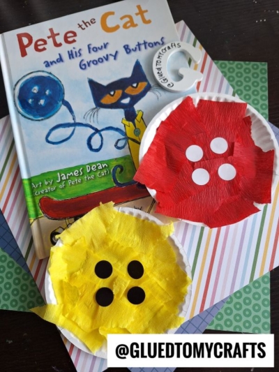 A copy of Pete the Cat and His Four Groovy Buttons lies on striped paper with two paper plate crafts resembling buttons—one red, one yellow—each with four white circles. @GLUEDTOMYCRAFTS is written at the bottom, perfect for summer craft ideas.