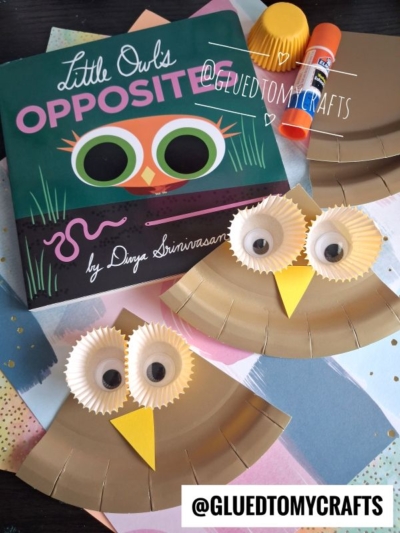 Children’s book “Little Owl’s Opposites” next to two owl crafts made from paper plates, googly eyes, and cupcake liners. Glue sticks and colored paper are also visible. @GLUEDTOMYCRAFTS watermark is over the image.