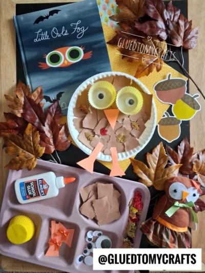 A children's owl craft with brown paper, googly eyes, and cupcake liners is shown alongside a book, glue, faux leaves, and an owl toy. Perfect for inspiring creativity, this adorable creation is a fun twist on the classic paper plate owl craft. The Instagram handle @GLUEDTOMYCRAFTS is at the bottom.