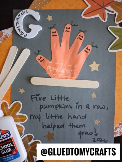 A handprint craft shows five orange pumpkins as fingers, Halloween faces drawn on them. Craft sticks, a glue bottle, stars, and fall leaves decorate the page, making it one of the perfect FALL CRAFTS FOR KIDS. The poem Five Little Pumpkins is written below.