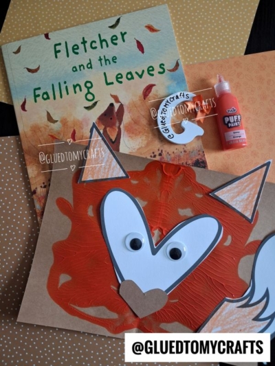 A children’s book titled Fletcher and the Falling Leaves, orange polka-dot paper, a paint splat fox face craft with googly eyes, white paint, and @GLUEDTOMYCRAFTS labeled on the image.