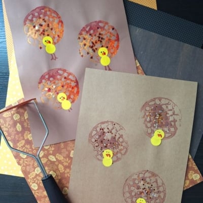 Two pieces of brown paper show turkey crafts made from painted potato masher prints for feathers and yellow paper for bodies, with craft supplies visible nearby. @GLUEDTOMYCRAFTS is written at the bottom.