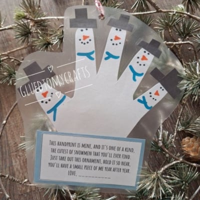 A laminated handprint ornament with fingers decorated as snowmen, featuring a poem about keeping a small piece of the childs year.