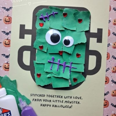 A handmade Halloween card featuring a Frankenstein monster made from torn green paper, googly eyes, and purple puff paint stitches, with the text Stitched together with love, from your little monster. Happy Halloween!.